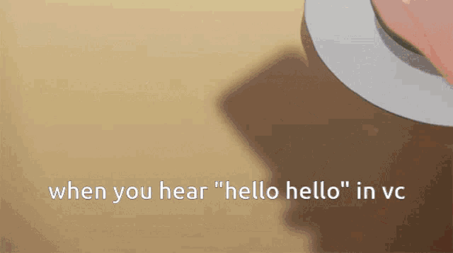 a person holding a cell phone with the words " when you hear hello hello in vc "
