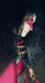 a woman with red paint on her face is holding a sword