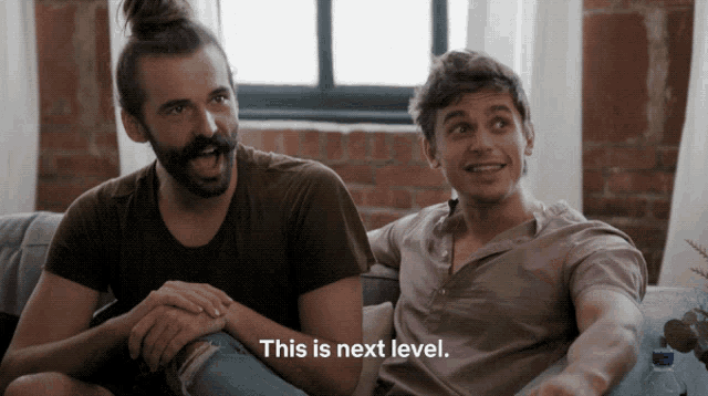 two men are sitting on a couch and one of them is saying " this is next level "