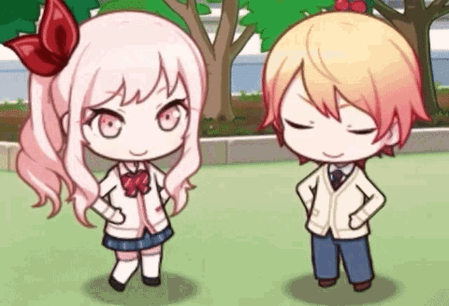 a boy and a girl are standing next to each other with their hands on their hips in a park .