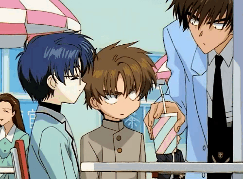 a man is giving a boy a drink in a pink and white cup