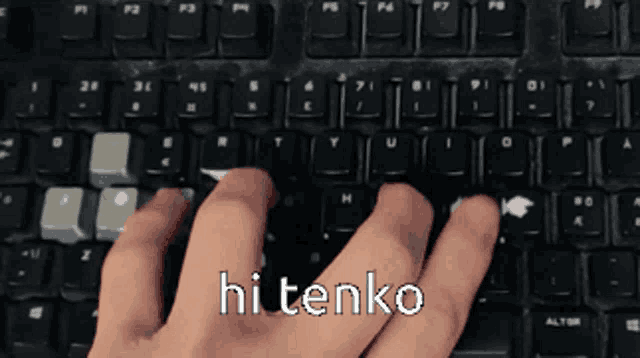 a person typing on a keyboard that says hi tenko on the bottom