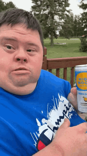 a man with down syndrome is holding a can of vodka