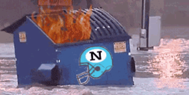 a dumpster with the letter n on it is burning