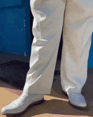 a person wearing white pants and white shoes