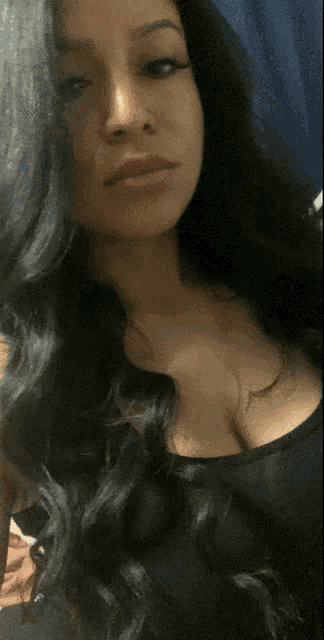 a woman with long black hair takes a selfie