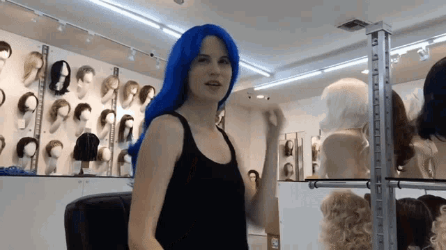 a woman wearing a blue wig in a store