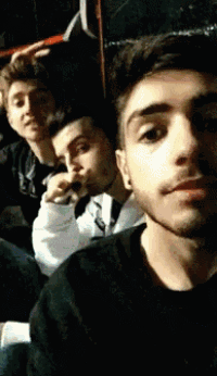 a group of young men are posing for a picture and one of them is wearing a black shirt