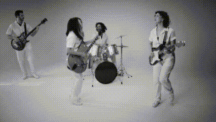 a group of people playing guitars and drums in a black and white photo