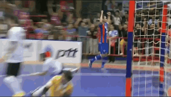 a blurred image of a soccer game with an advertisement for ptt