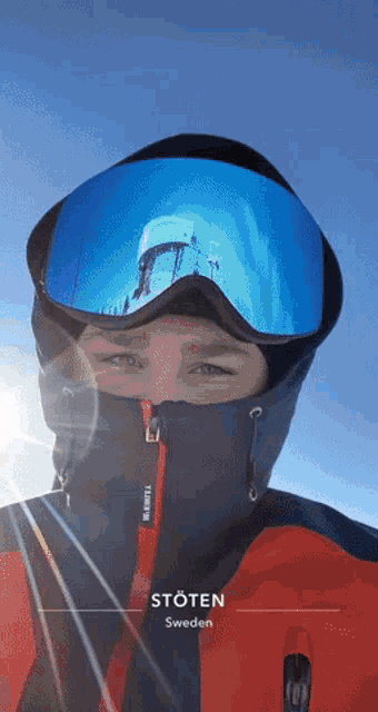 a man wearing a ski goggles and a jacket with stoten sweden on the bottom