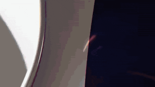 a close up of an airplane window with a light coming through