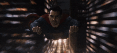 a man in a superman costume is flying in the air