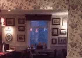 a room with a lot of pictures on the wall and a window