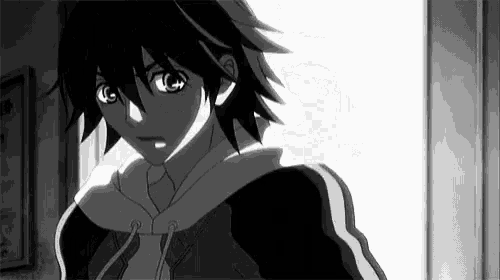 a black and white photo of a boy in a hoodie standing in front of a door