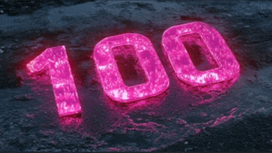 the number 100 is lit up in pink on the ground