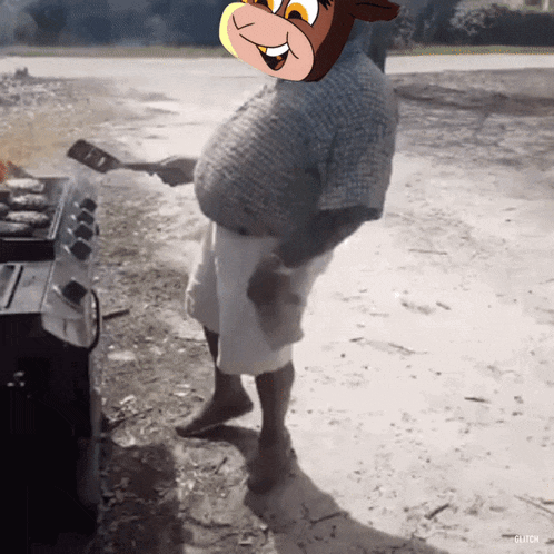a man is cooking on a grill with a picture of a cartoon cow on his head