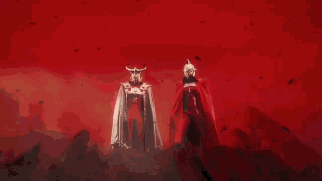 two superheros are standing next to each other with one wearing a red cape with an a on it