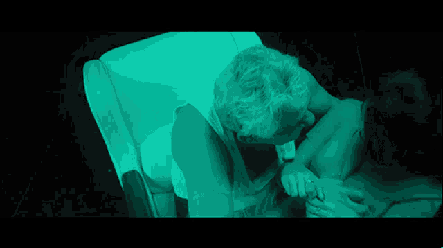 a man and woman kissing in a dark room