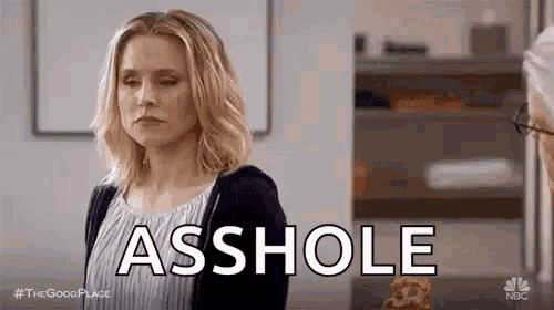 a woman is standing in front of a man with her eyes closed and the word asshole written on her face .
