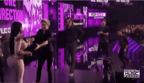 a group of people standing on a stage with a sign that says pop rock on it