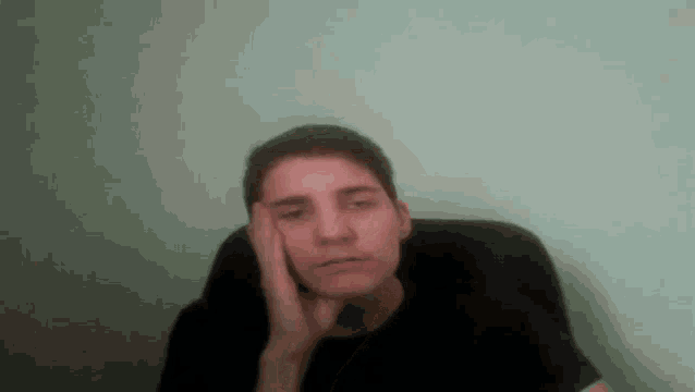 a man with his hand on his face looks tired