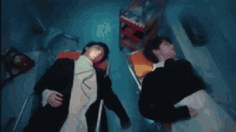 a couple of people are laying in a hospital bed .