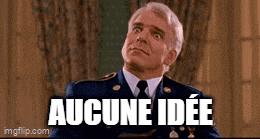 a man in a suit and tie is standing in front of a sign that says aucune ide .