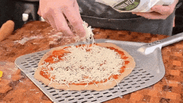Adding Cheese The Hungry Hussey GIF - Adding Cheese The Hungry Hussey Sprinkling Some Cheese GIFs