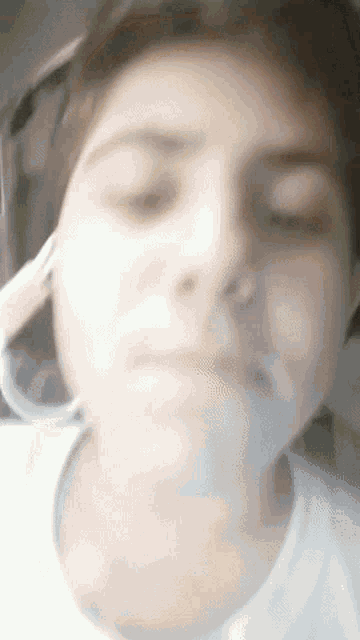 a close up of a person 's face with their eyes closed