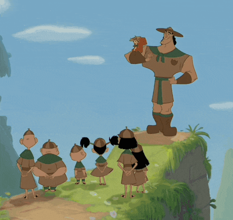 a group of people standing on top of a hill with a man in a hat standing in the middle