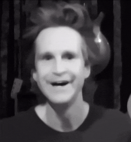 a black and white photo of a man 's face with his mouth open