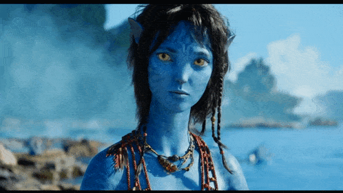 a woman with a blue face and yellow eyes is wearing a necklace