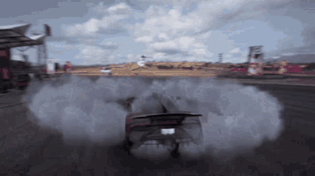 a car with a license plate that says ' lg ' on it is doing a burnout