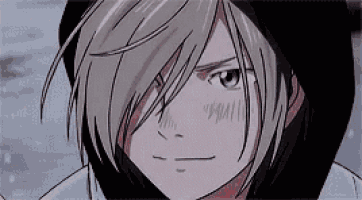 a close up of a person 's face with long hair and a hood on .