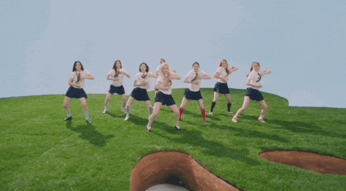 a group of girls are standing on top of a giant clover