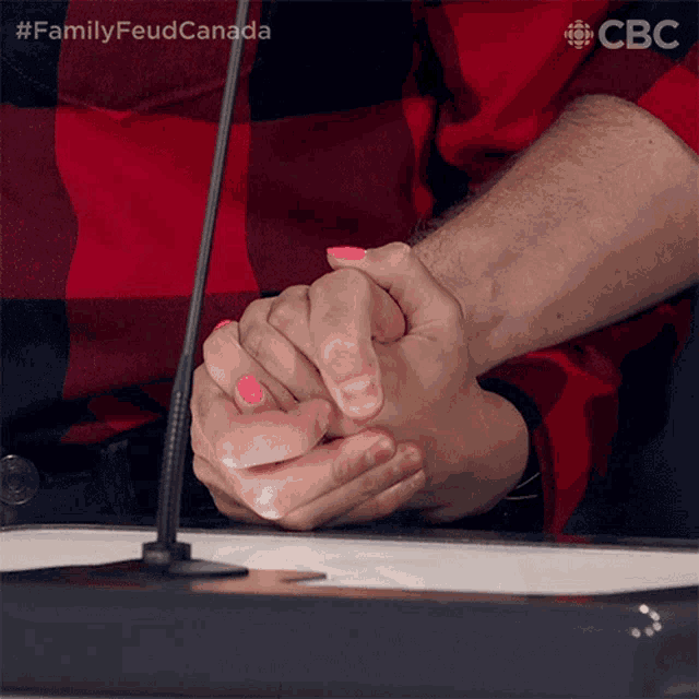 a man and woman holding hands with pink nail polish on their nails ..