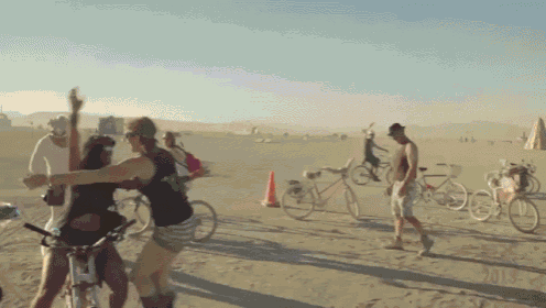 a group of people riding bikes in the desert