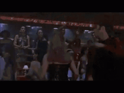 a group of people are dancing in a club