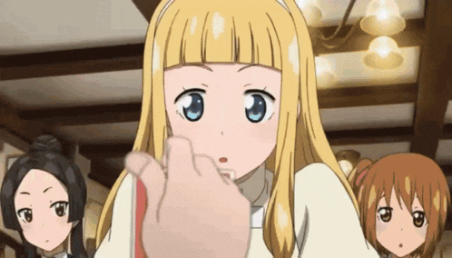 a girl with blonde hair and blue eyes is being touched by a person