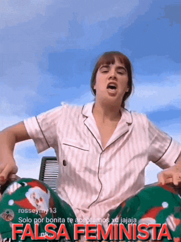 a woman wearing a striped shirt and green pants says " falsa feminista " on the bottom