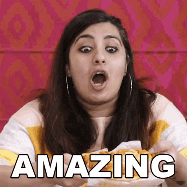 a woman is eating a sandwich and the word amazing is on the screen