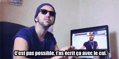 a man wearing sunglasses and a hat says " c'est pas possible " in front of a computer monitor