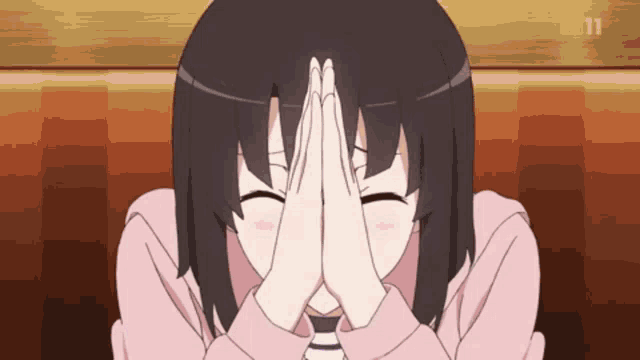a girl is covering her face with her hands and smiling ..