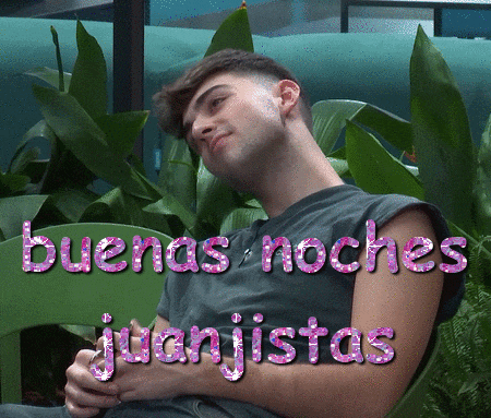 a man is laying on a green chair with the words buenas noches juanistas written on his arm
