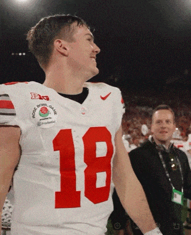 a football player wearing a white jersey with the number 18