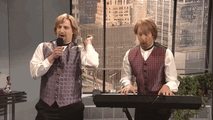 two men are singing and playing a keyboard in front of a window