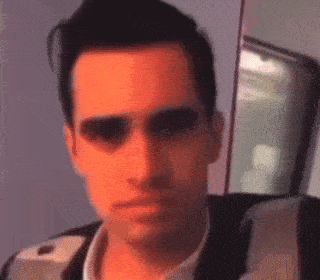 a close up of a man 's face with a red background .