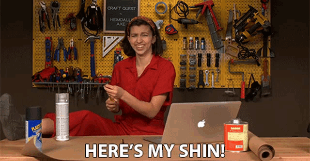 a woman sitting in front of a laptop with the words here 's my shin below her