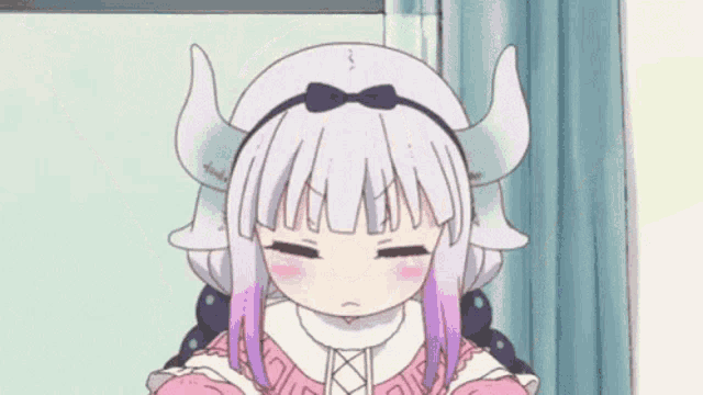 a girl with horns is sitting in a chair with her eyes closed .
